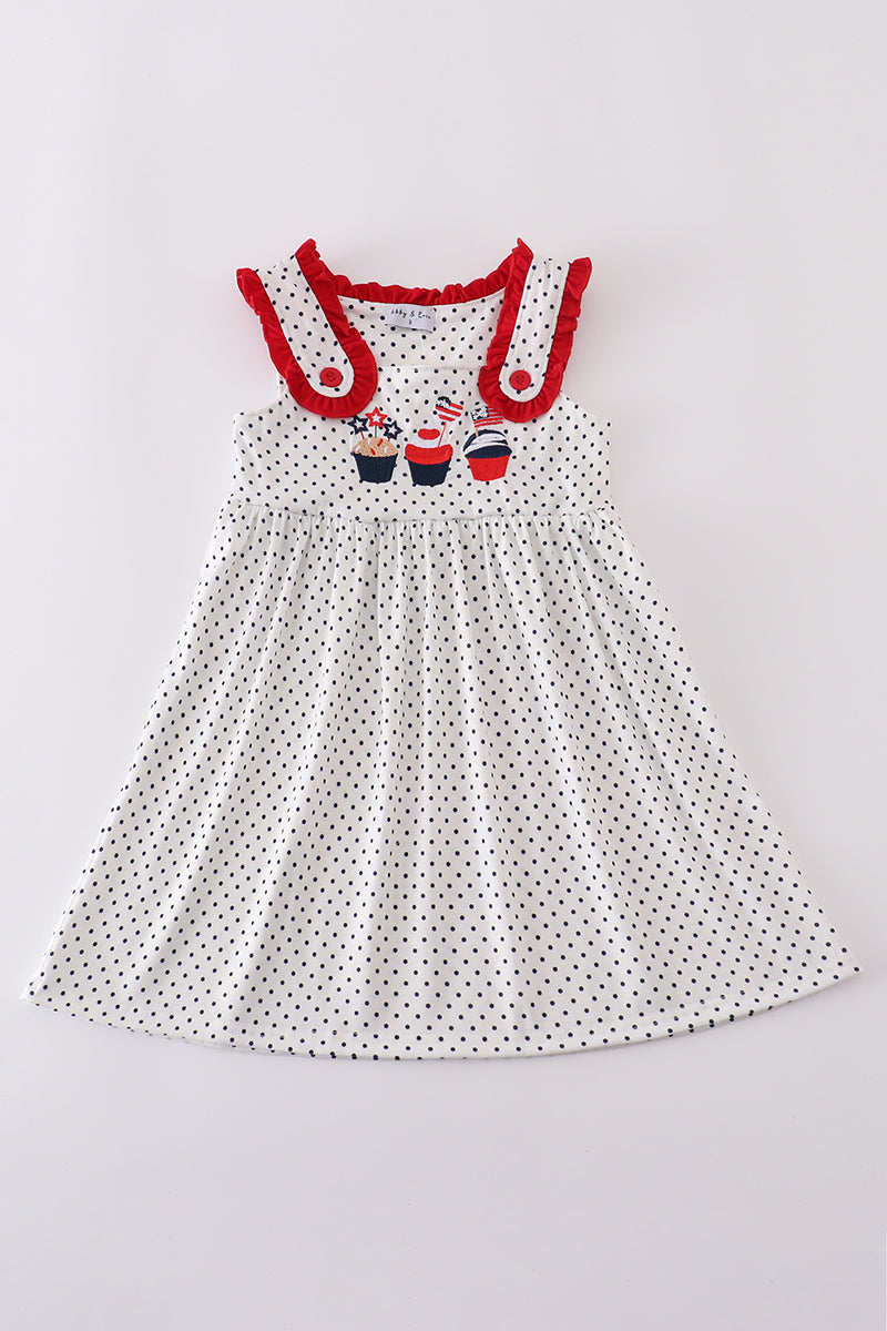 A charming red dress with cake embroidery and polka dots, perfect for parties.