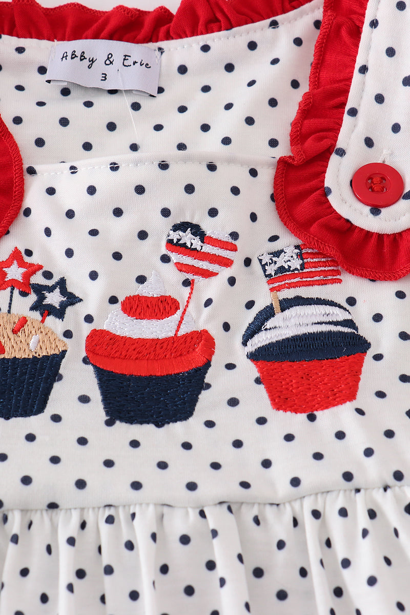 A charming red dress with cake embroidery and polka dots, perfect for parties.