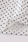 A charming red dress with cake embroidery and polka dots, perfect for parties.