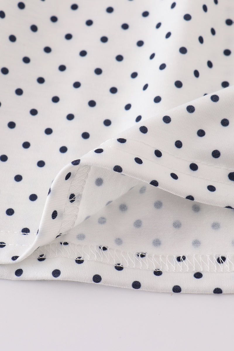 A charming red dress with cake embroidery and polka dots, perfect for parties.