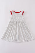 A charming red dress with cake embroidery and polka dots, perfect for parties.