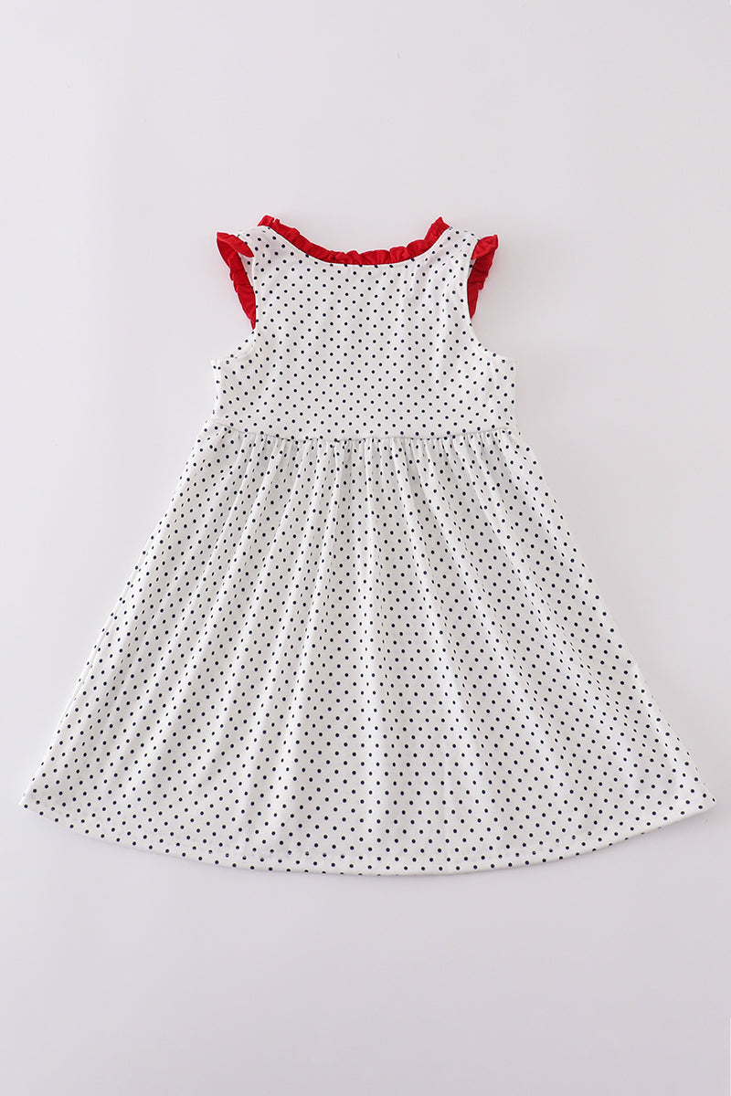 A charming red dress with cake embroidery and polka dots, perfect for parties.