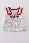 A charming red dress with cake embroidery and polka dots, perfect for parties.
