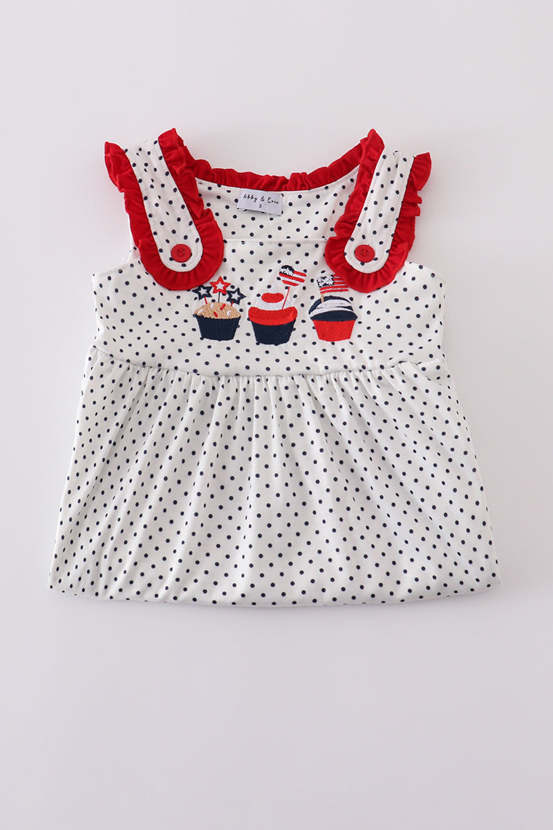 A charming red dress with cake embroidery and polka dots, perfect for parties.