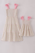 Pink lemon print smocked dress with bow, tiered design, perfect for mom and me.