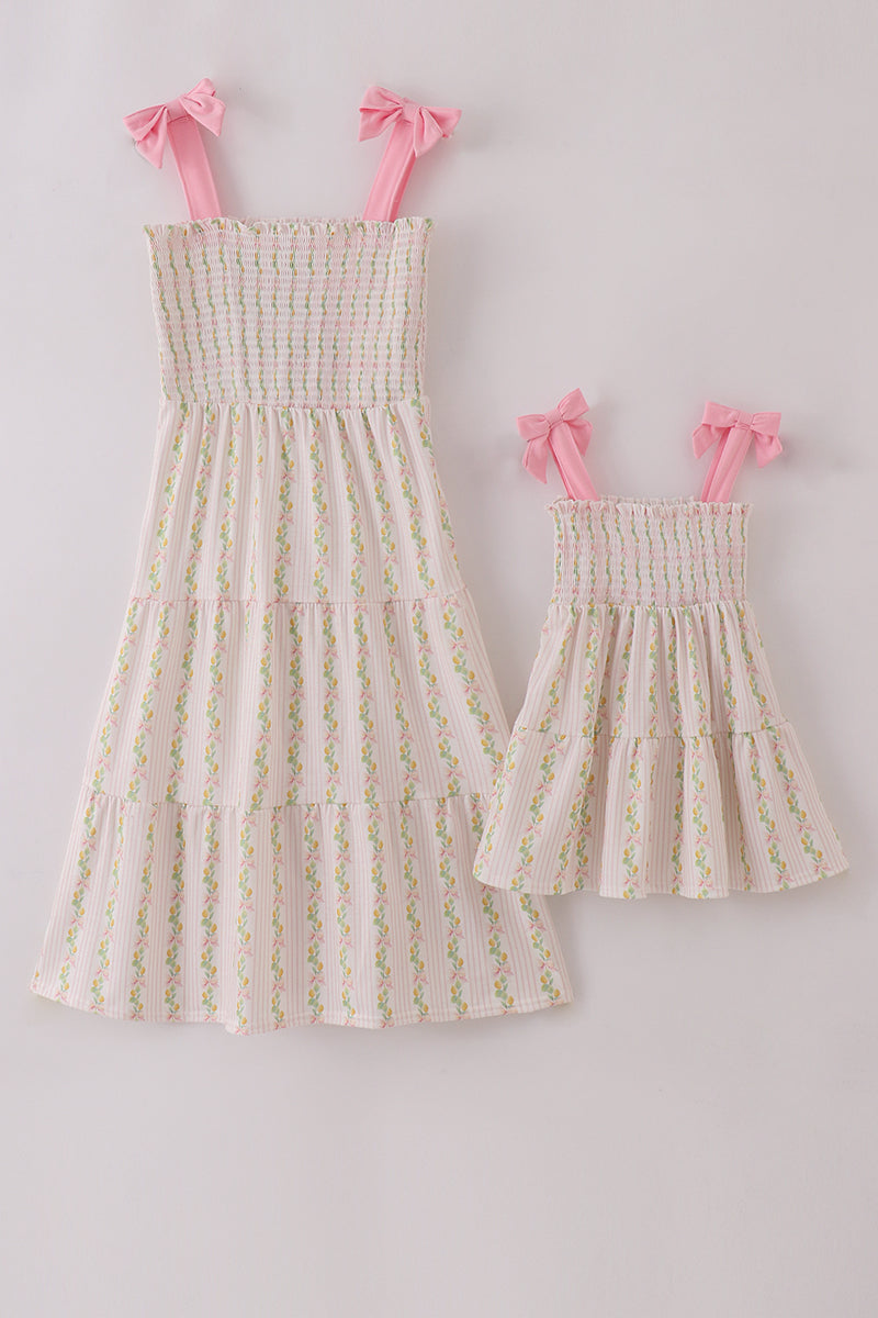 Pink lemon print smocked dress with bow, tiered design, perfect for mom and me.