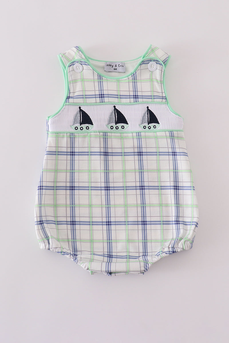 A charming green seersucker bubble with sailboat embroidery, perfect for summer fun.