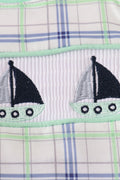 A charming green seersucker bubble with sailboat embroidery, perfect for summer fun.