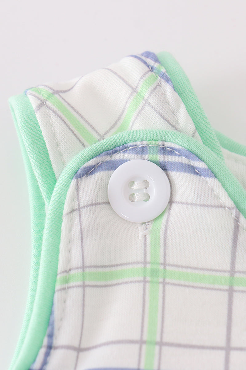 A charming green seersucker bubble with sailboat embroidery, perfect for summer fun.