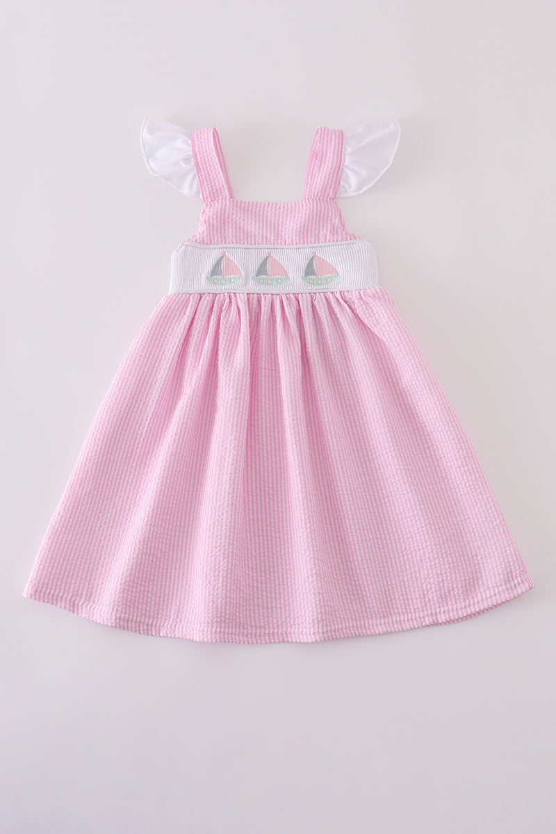 Pink stripe seersucker dress with sailboat embroidery and smocked bodice, perfect for summer.