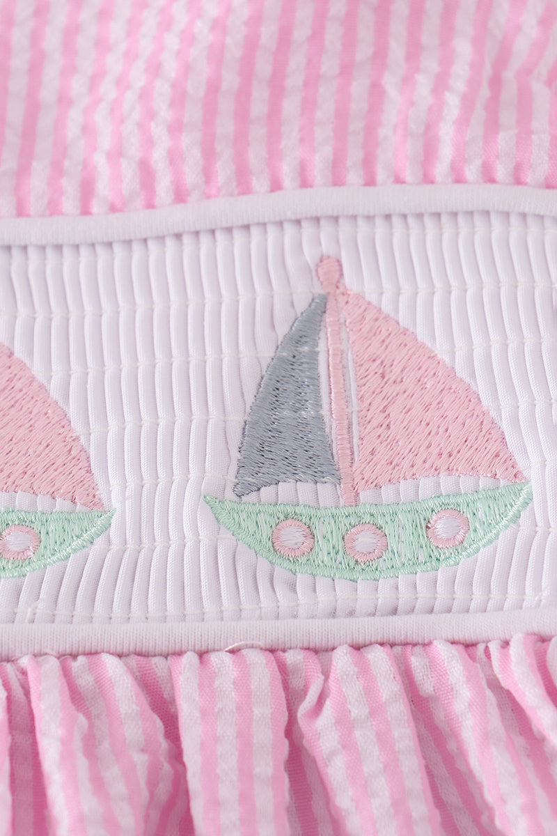 Pink stripe seersucker dress with sailboat embroidery and smocked bodice, perfect for summer.