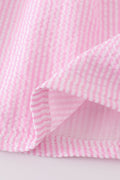 Pink stripe seersucker dress with sailboat embroidery and smocked bodice, perfect for summer.