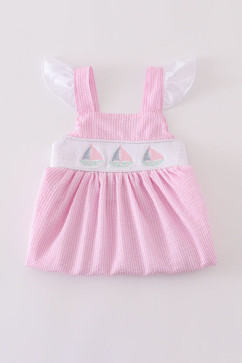 Pink stripe seersucker dress with sailboat embroidery and smocked bodice, perfect for summer.