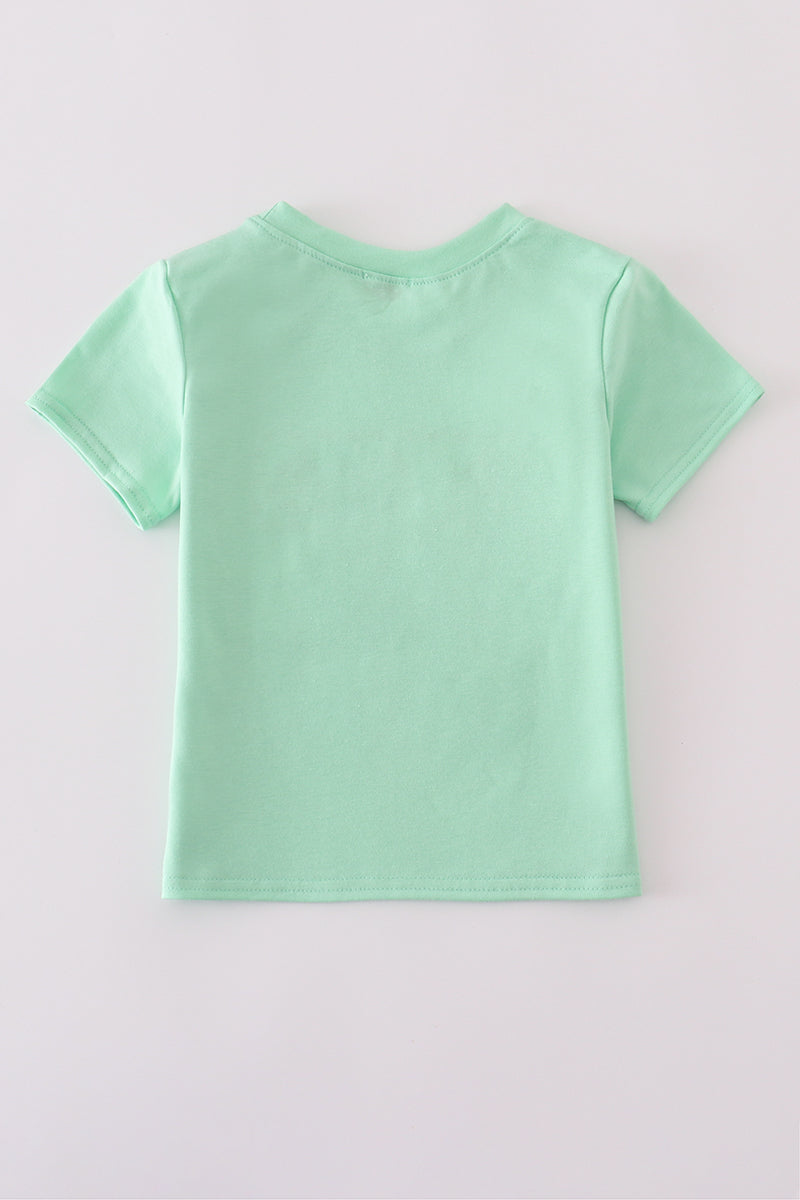 Green seersucker top with playful sailboat embroidery, perfect for summer adventures.