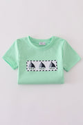 Green seersucker top with playful sailboat embroidery, perfect for summer adventures.