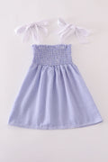 Blue stripe seersucker smocked dress with ruffled sleeves, perfect for family outings.