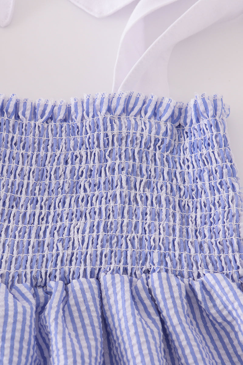 Blue stripe seersucker smocked dress with ruffled sleeves, perfect for family outings.