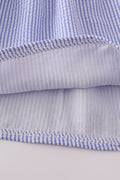 Blue stripe seersucker smocked dress with ruffled sleeves, perfect for family outings.