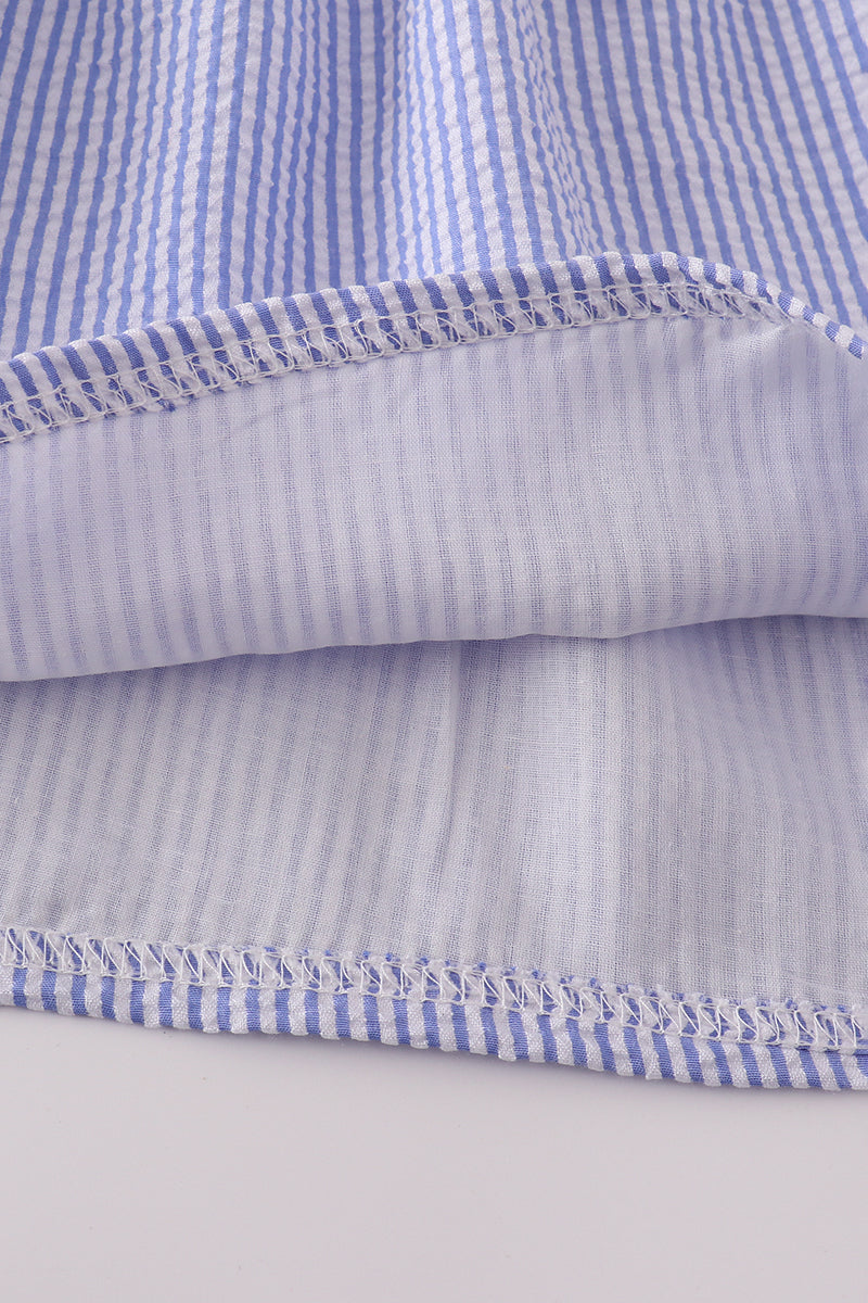 Blue stripe seersucker smocked dress with ruffled sleeves, perfect for family outings.
