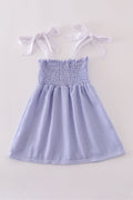 Blue stripe seersucker smocked dress with ruffled sleeves, perfect for family outings.