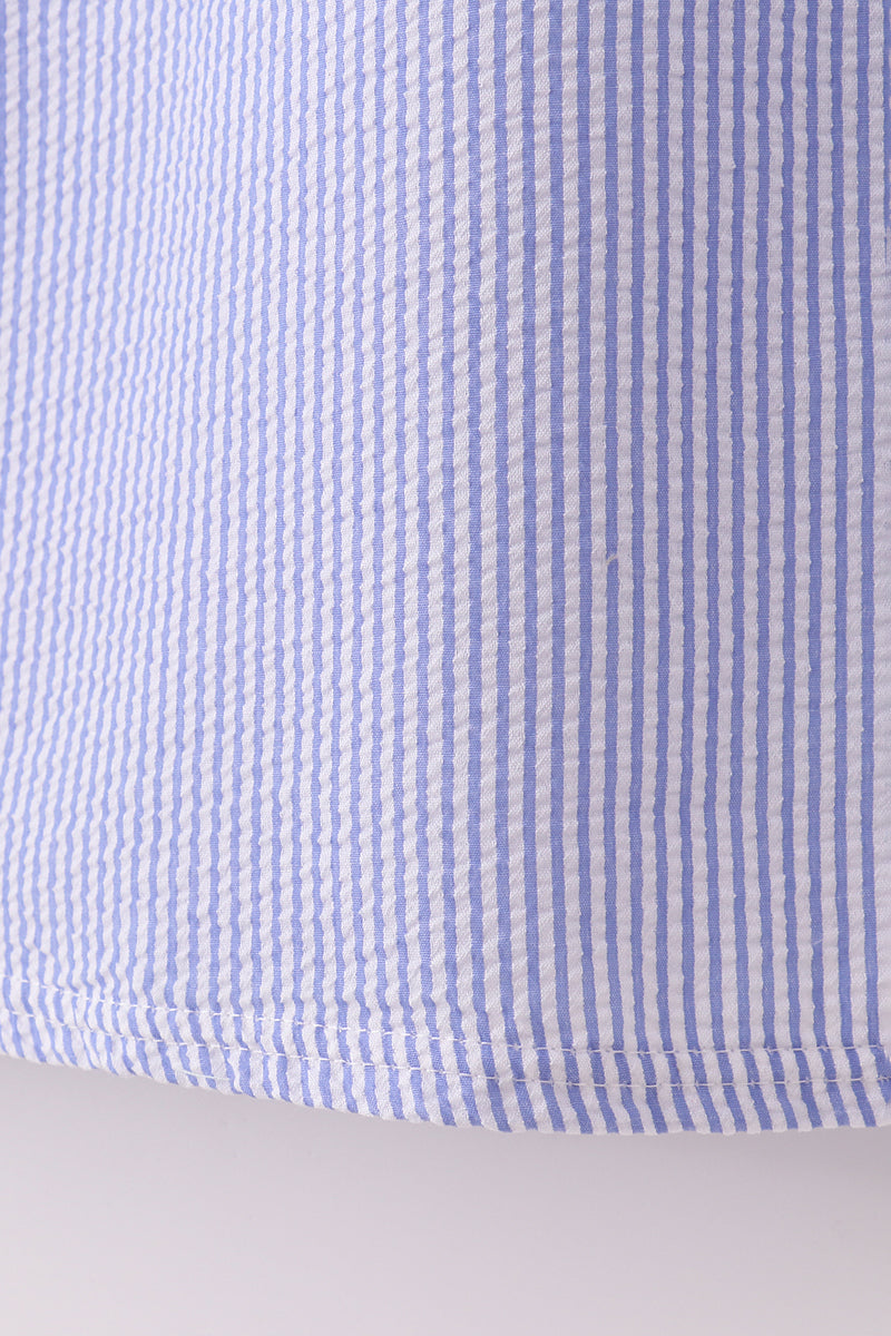 Blue stripe seersucker smocked dress with ruffled sleeves, perfect for family outings.