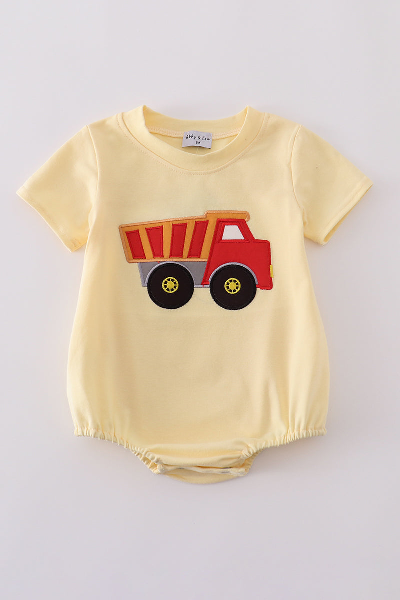 Bright yellow bubble romper with a playful truck applique, perfect for toddlers.