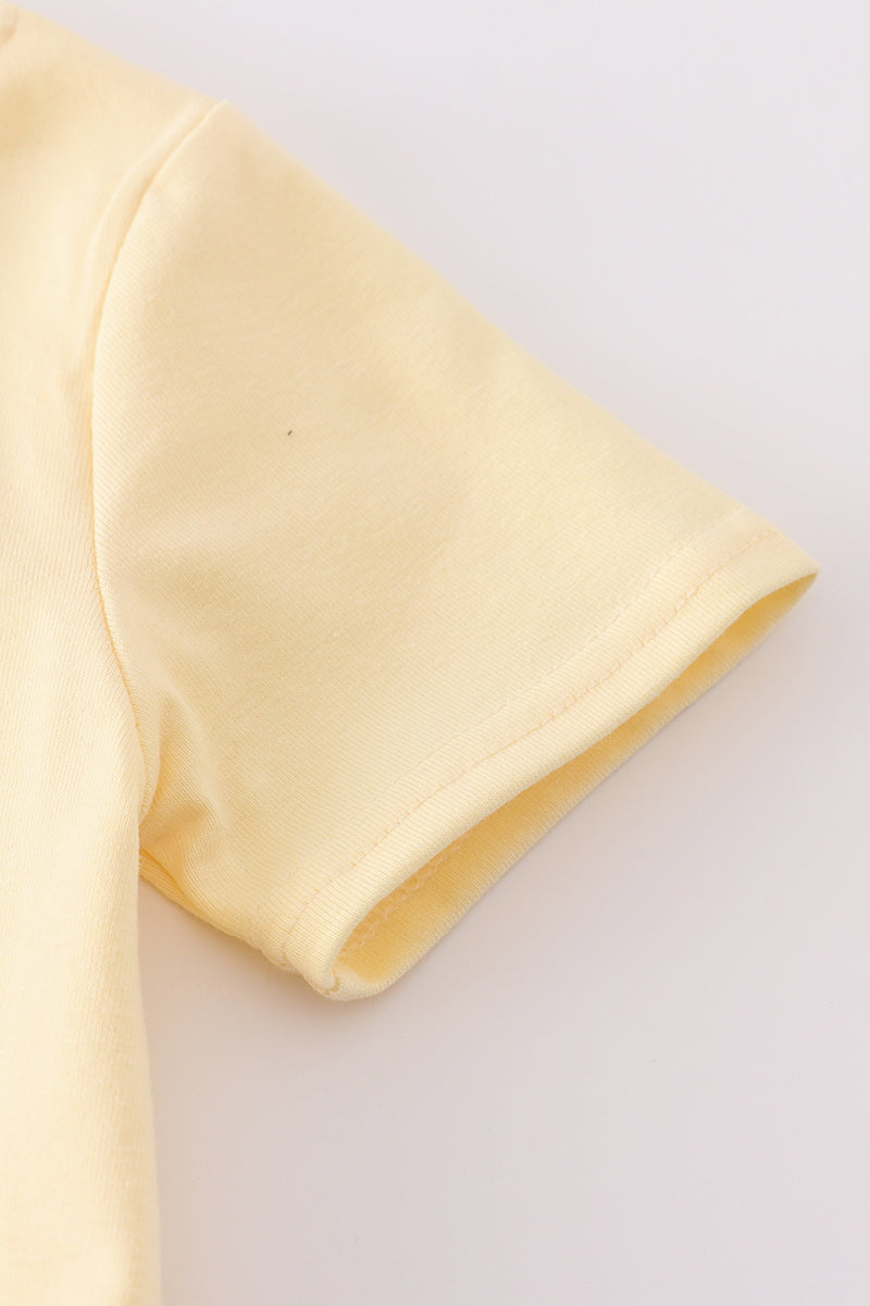 Bright yellow bubble romper with a playful truck applique, perfect for toddlers.