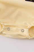 Bright yellow bubble romper with a playful truck applique, perfect for toddlers.