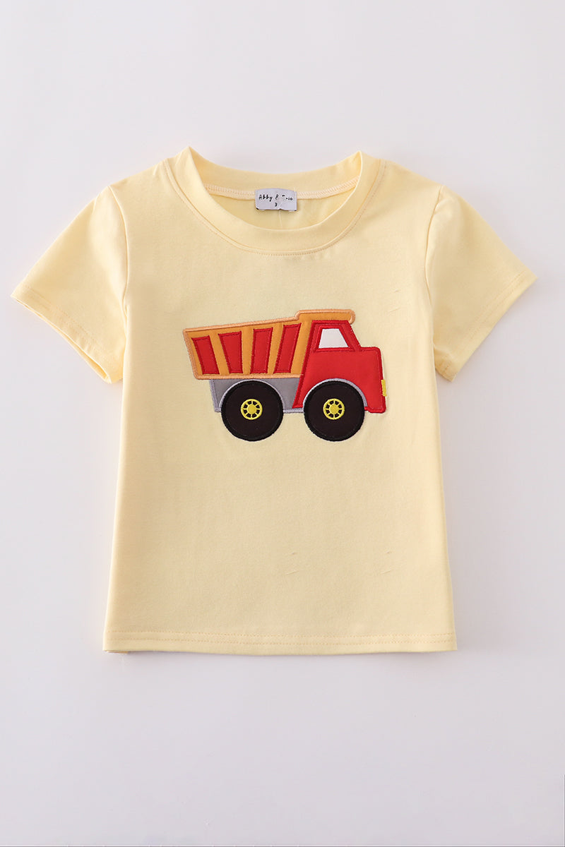 Bright yellow top for kids with a playful truck applique design.