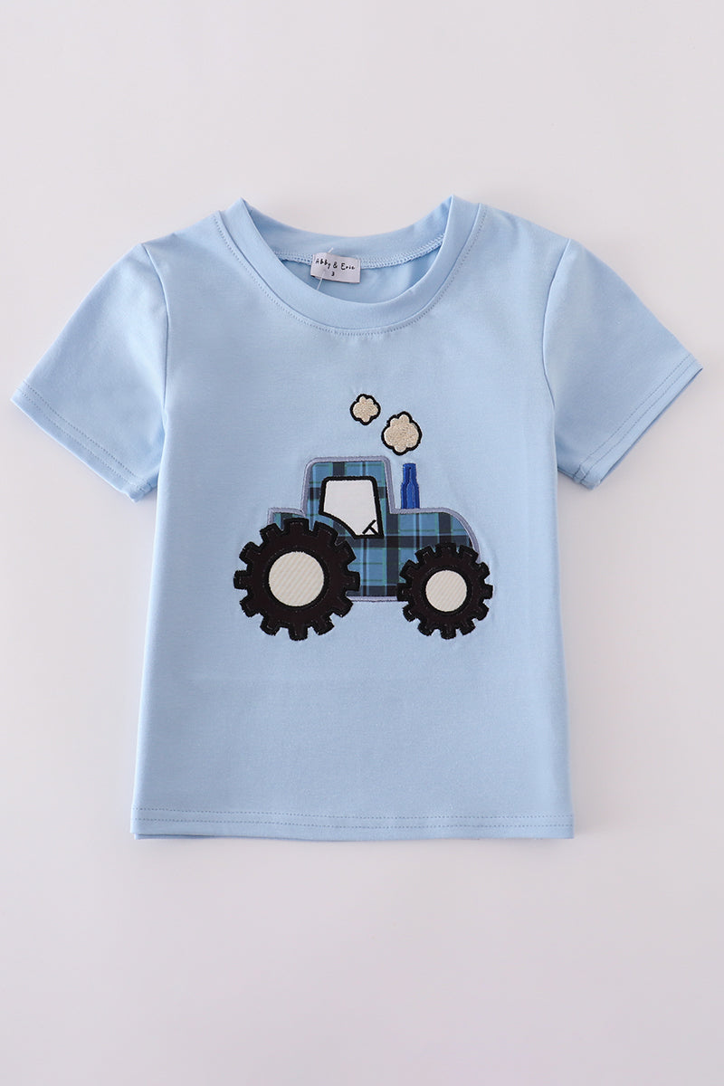 Blue long-sleeve top with cheerful yellow tractor applique, perfect for playful adventures.