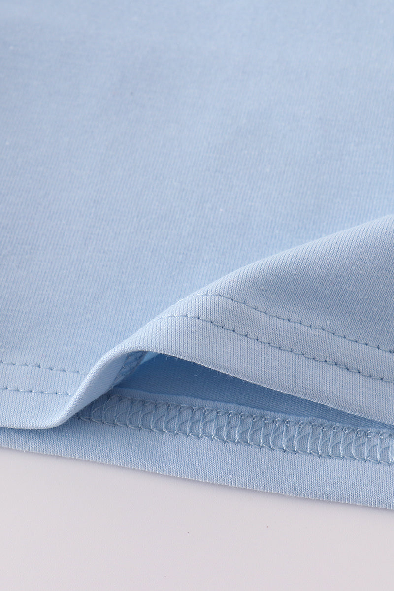 Blue long-sleeve top with cheerful yellow tractor applique, perfect for playful adventures.