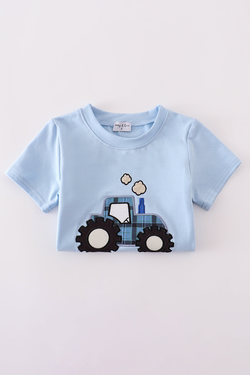 Blue long-sleeve top with cheerful yellow tractor applique, perfect for playful adventures.