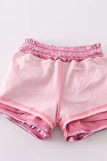 Pink laser shorts for kids with a vibrant, colorful geometric pattern.