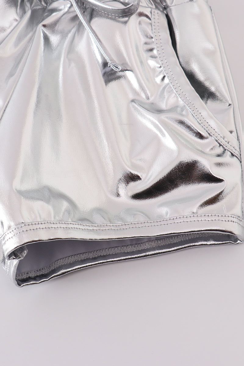 Shiny silver shorts with a fun, futuristic laser pattern, perfect for playtime.