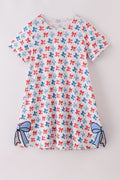 Matching mom and daughter dresses with cute bow appliques on a playful print.