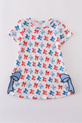 Matching mom and daughter dresses with cute bow appliques on a playful print.