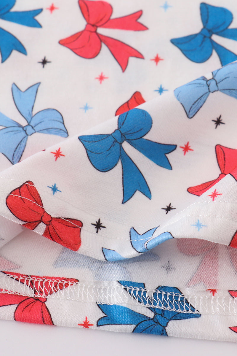 Matching mom and daughter dresses with cute bow appliques on a playful print.