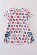 Matching mom and daughter dresses with cute bow appliques on a playful print.