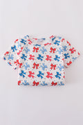 Matching mom and daughter dresses with cute bow appliques on a playful print.