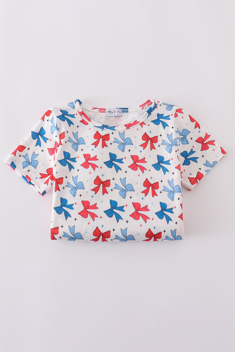 Matching mom and daughter dresses with cute bow appliques on a playful print.