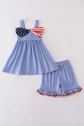Adorable blue gingham shorts set with a playful flag bow detail.