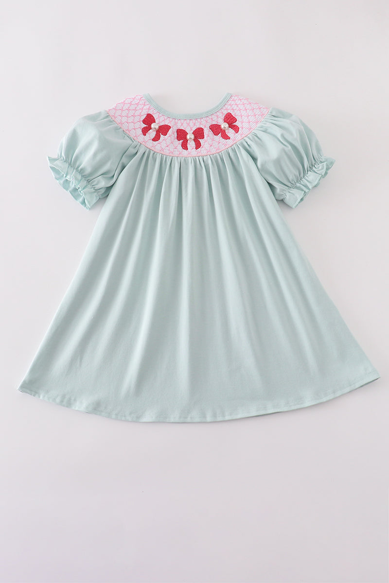 Blue bow pearl smocked dress with delicate embroidery, perfect for special occasions.