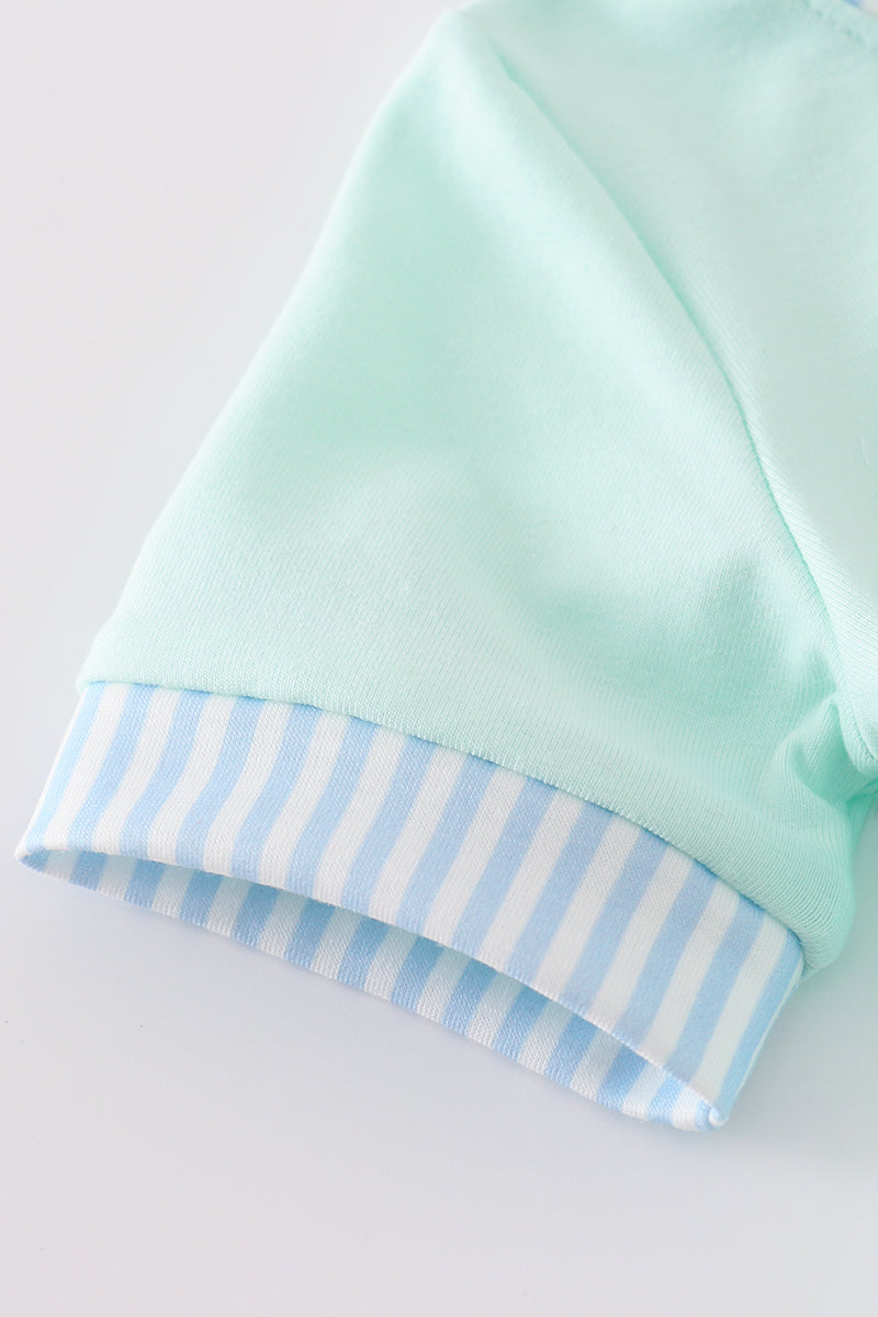 Mint green bubble romper with a whimsical castle applique, perfect for playtime.