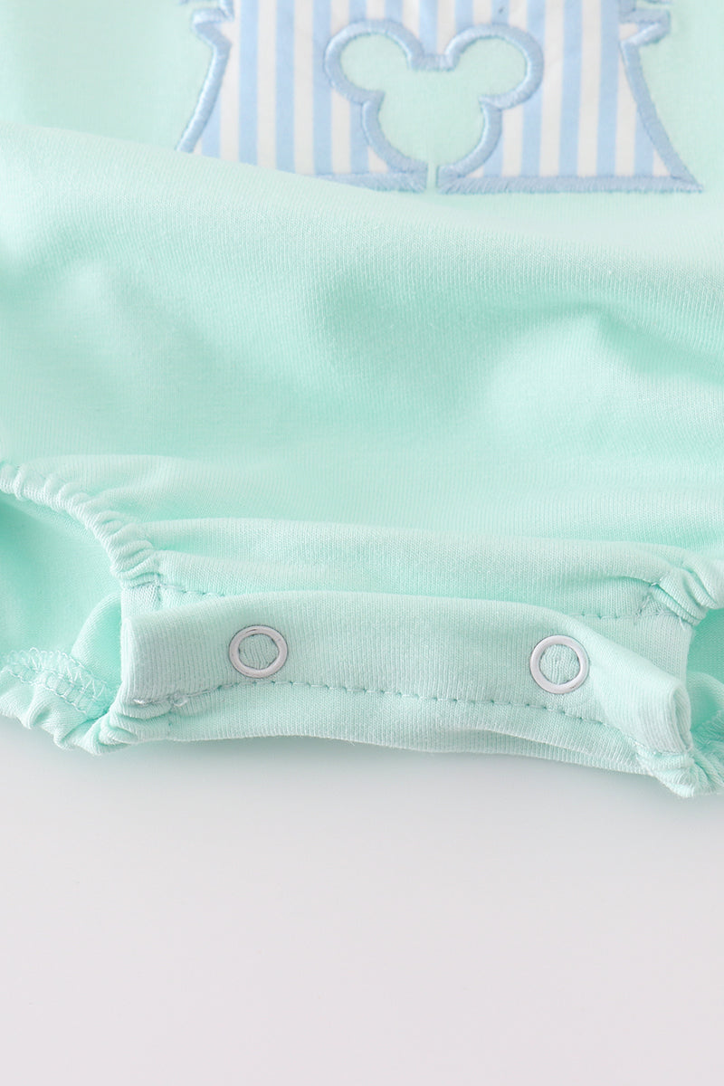 Mint green bubble romper with a whimsical castle applique, perfect for playtime.