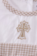 Adorable bubble romper with intricate cross embroidery, perfect for special occasions.