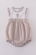 A cozy, pastel-colored bubble romper with delicate cross embroidery for toddlers.