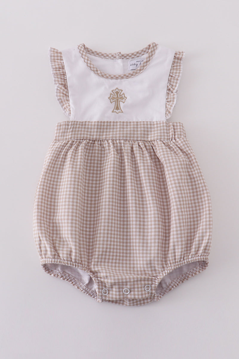 A cozy, pastel-colored bubble romper with delicate cross embroidery for toddlers.