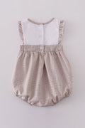 A cozy, pastel-colored bubble romper with delicate cross embroidery for toddlers.