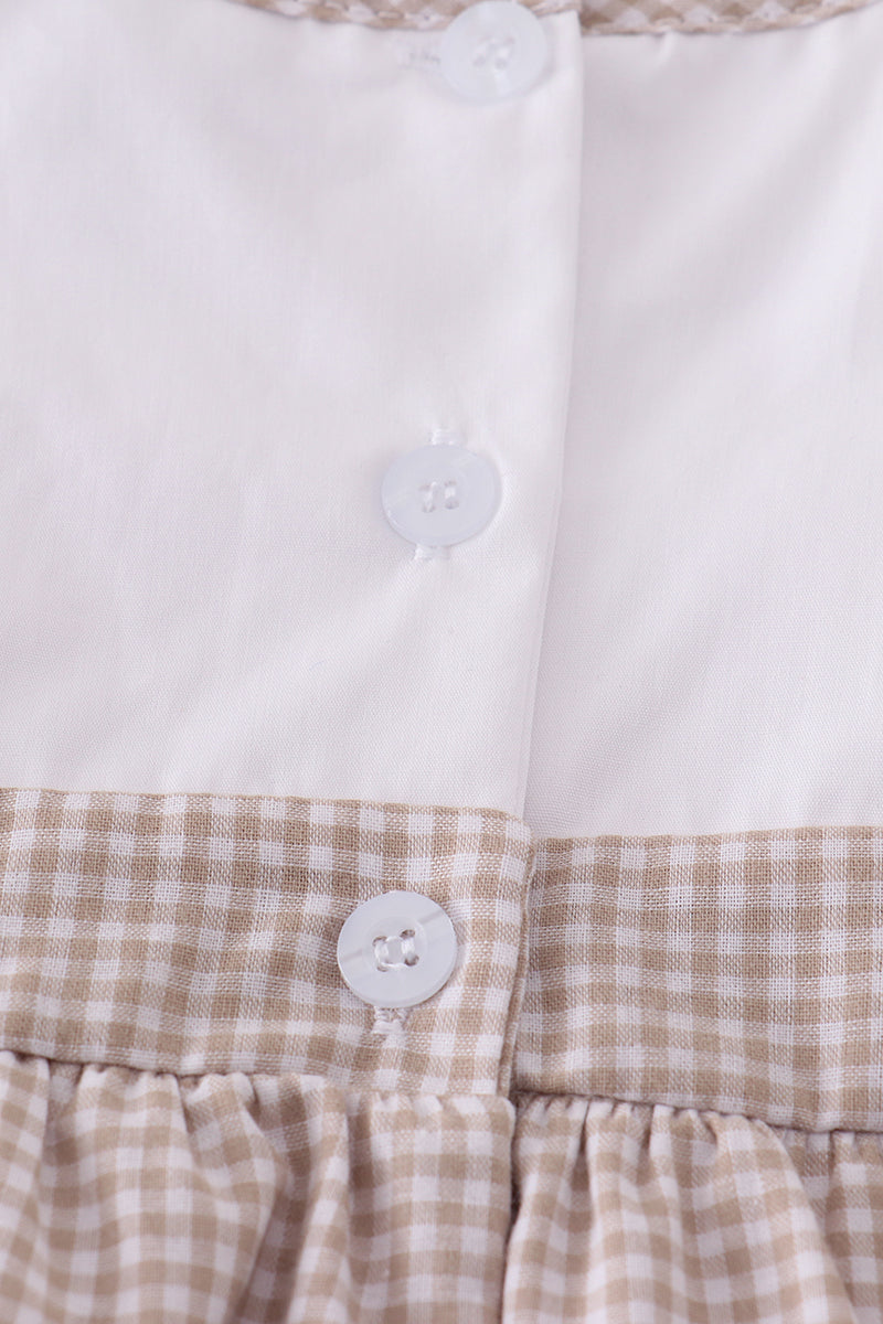 A cozy, pastel-colored bubble romper with delicate cross embroidery for toddlers.