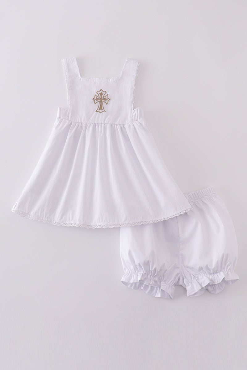 Soft, white romper with delicate cross embroidery, perfect for cozy playtime.